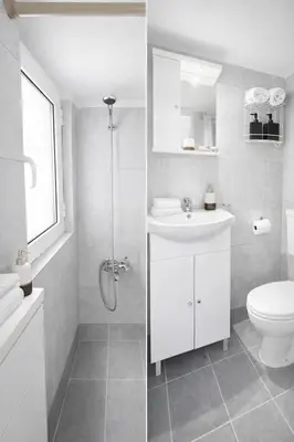 a white bathroom with a toilet and a sink at Cozy Estia in Athens