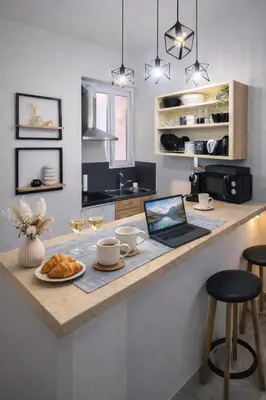 a kitchen with a counter with a laptop on it at Cozy Estia in Athens