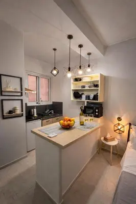 a kitchen with a island with a bowl of fruit on it at Cozy Estia in Athens