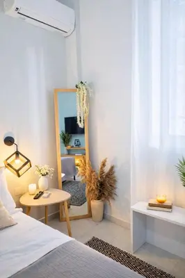 a bedroom with a mirror and a bed and a table at Cozy Estia in Athens