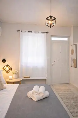 a bedroom with two towels on a bed at Cozy Estia in Athens