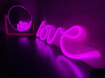 a pink neon sign in a room with a mirror at Cosy full apartment in Athens