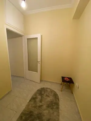 an empty room with a door and a rug at Cosy full apartment in Athens