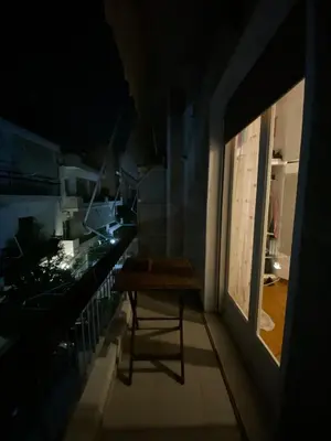 a small room with a table on a balcony at Cosy full apartment in Athens
