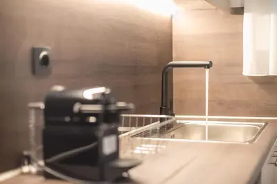 a kitchen counter with a sink and a faucet at Zografou Urban Apartments, A2Zen in Athens