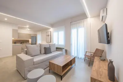 a living room with a couch and a table at Zografou Urban Apartments, A2Zen in Athens