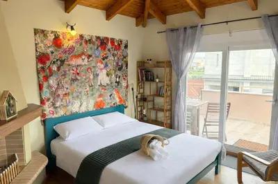 a bedroom with a bed and a painting on the wall at Purerest Entire Private Villa in Athens