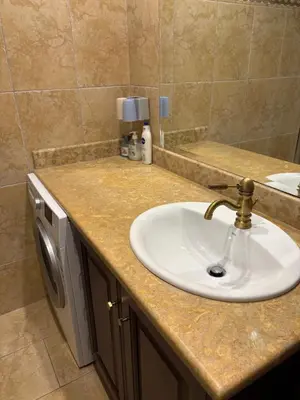 a bathroom counter with a sink and a mirror at Purerest Entire Private Villa in Athens