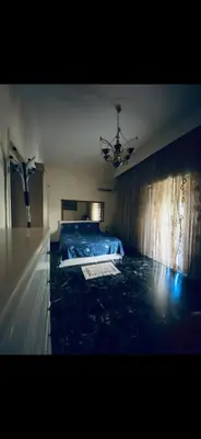 a bedroom with a bed with a blue blanket on it at Master private room in Athens