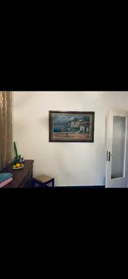 a living room with a painting on the wall at Master private room in Athens