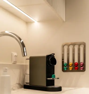 a kitchen with a counter top with a coffee maker at ERE Acropolis Courtyard in Athens