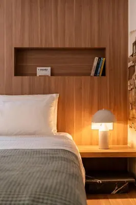 a bedroom with a bed and a desk with a lamp at ERE Acropolis Courtyard in Athens