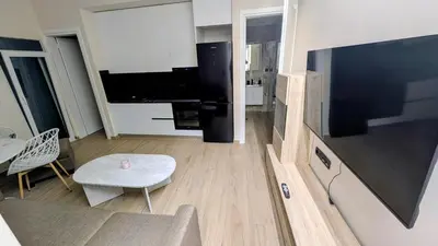 a living room with a couch and a large television at Arhontoula Single-Family 2 Bedroom Home Kalithea in Athens