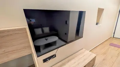 a large flat screen tv hanging on a wall at Arhontoula Single-Family 2 Bedroom Home Kalithea in Athens