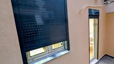 a window with a black blind on a building at Arhontoula Single-Family 2 Bedroom Home Kalithea in Athens