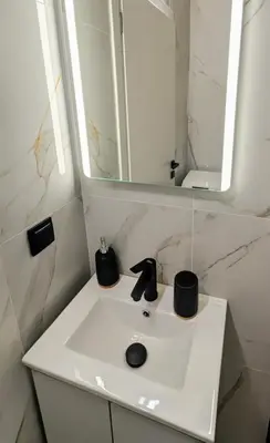 a bathroom with a white sink with a mirror at Arhontoula Single-Family 2 Bedroom Home Kalithea in Athens