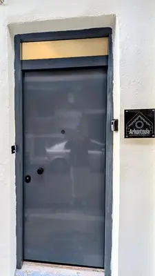 a blue garage door with a sign on it at Arhontoula Single-Family 2 Bedroom Home Kalithea in Athens