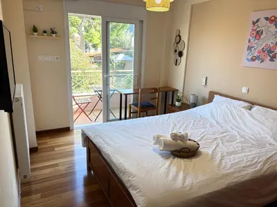 a bedroom with a bed with a stuffed animal on it at Purerest villa room A en suite in Athens
