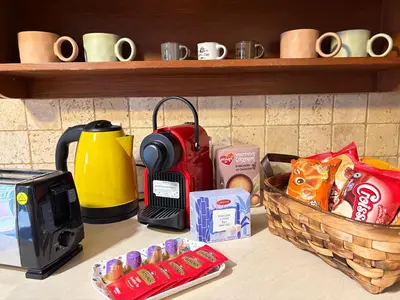 a counter with a coffee maker and a basket of food at Purerest villa room A en suite in Athens