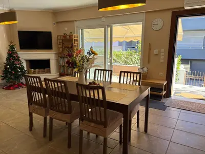 a dining room with a table and chairs and a christmas tree at Purerest villa room A en suite in Athens