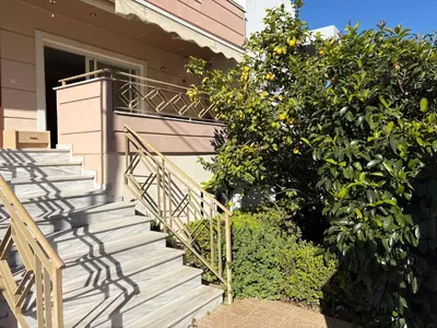 a staircase leading to a house with an orange tree at Purerest villa room A en suite in Athens