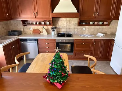 a christmas tree on a wooden table in a kitchen at Purerest villa room A en suite in Athens