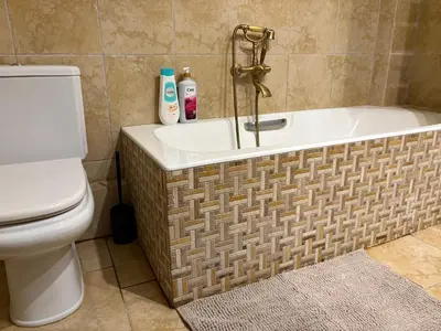 a bathroom with a bath tub and a toilet at Purerest villa room A en suite in Athens