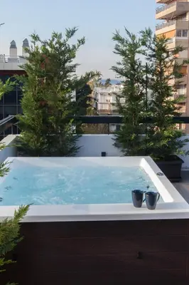 a hot tub on the roof of a building at Penthouse in the Heart of Glyfada in Athens