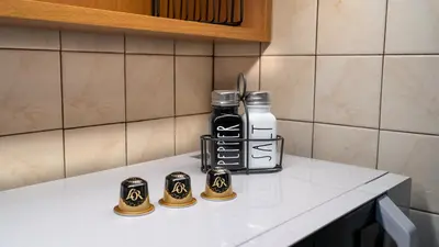 a counter with two coffee cups and a bottle on it at Zeas Yacht View in Piraeus