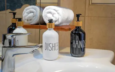 two bottles of disinfectants sitting on a bathroom sink at Zeas Yacht View in Piraeus