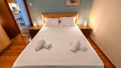 a bedroom with a bed with three towels on it at Zeas Yacht View in Piraeus