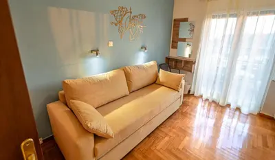 a living room with a couch in a room at Zeas Yacht View in Piraeus