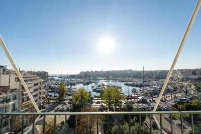 a view of a harbor from a balcony of a building at Zeas Yacht View in Piraeus