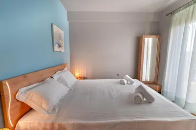 a bedroom with a large white bed with towels on it at Zeas Yacht View in Piraeus