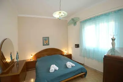 a bedroom with a bed with two towels on it at DAT Comfy house in Kalívia Thorikoú