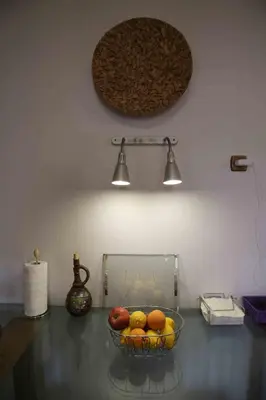 a bowl of fruit on a table with two lights at DAT Comfy house in Kalívia Thorikoú