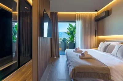 a bedroom with a large bed with towels on it at The HostMaster Skyline Tower View Suite in Athens