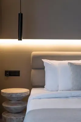 a bedroom with a bed and a nightstand next to a bed at The HostMaster Skyline Tower View Suite in Athens