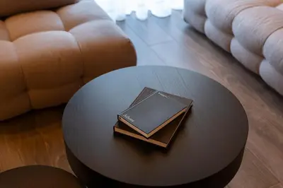 a book sitting on top of a table in a living room at The HostMaster Skyline Tower View Suite in Athens