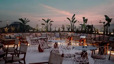 a group of tables and chairs on a roof at The HostMaster Skyline Tower View Suite in Athens