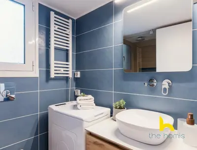 a bathroom with a sink and a toilet and a mirror at Modern Studio Escape near Seaside & Marina! in Athens