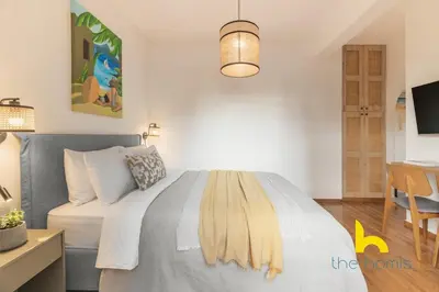 a bedroom with a bed and a table and a desk at Modern Studio Escape near Seaside & Marina! in Athens