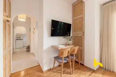 a dining room with a table and a tv on a wall at Modern Studio Escape near Seaside & Marina! in Athens