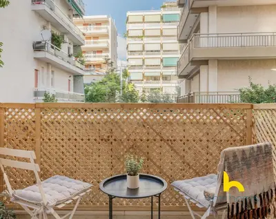 a patio with two chairs and a table on a balcony at Modern Studio Escape near Seaside & Marina! in Athens