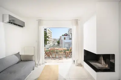 a living room with a couch and a fireplace at Lux Lux & modern Apt 5 min Piraeus port - Free Parking in Piraeus