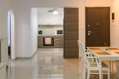 a kitchen and dining room with a table and chairs at Lux Lux & modern Apt 5 min Piraeus port - Free Parking in Piraeus