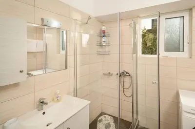 a bathroom with a shower and a sink at Lux Lux & modern Apt 5 min Piraeus port - Free Parking in Piraeus
