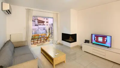 a living room with a couch and a tv at Lux Lux & modern Apt 5 min Piraeus port - Free Parking in Piraeus