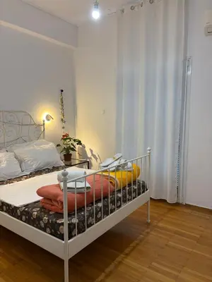 a bedroom with a bed and a table in it at Dreaming of Greece a4 in Athens