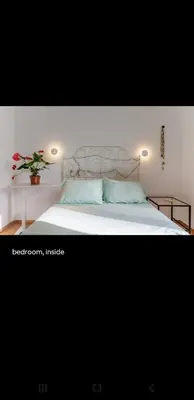 a bedroom with a white bed with a plant on it at Dreaming of Greece a4 in Athens
